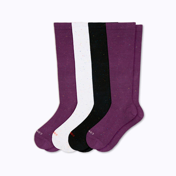 Set of four knee-high socks in potent, white, and galaxy on a white background