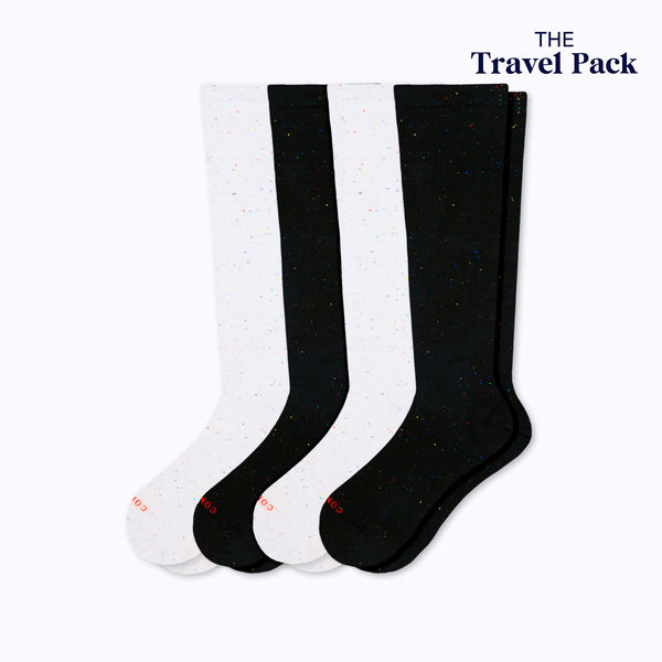 Two pairs of galaxy black and white stargazer socks labeled 'The Travel Pack' on a white background.