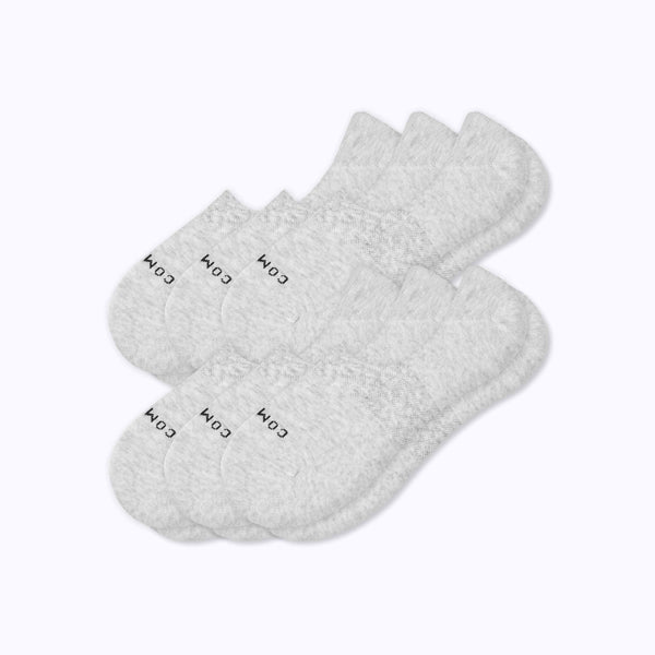 six pairs of low-cut ankle socks in a light heather gray color, arranged in a fan shape on a plain white background.