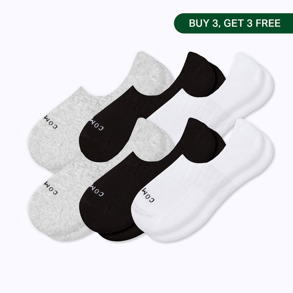 Six pairs of low-cut no-show socks arranged in an overlapping fan: two light heather gray and two white, two black. Banner in upper right corner with 'Buy 3, Get 3 Free'