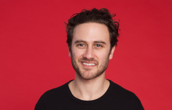 Photo of Founder & CEO Andrew Ferenci against a red backdrop