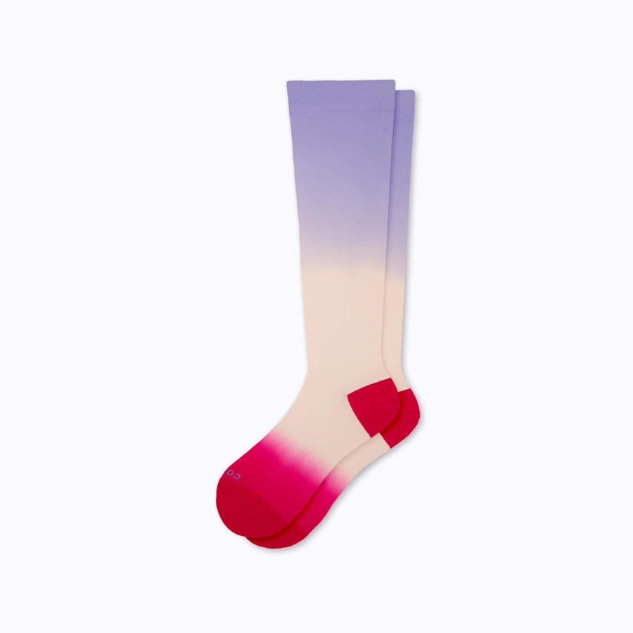 a pair of knee-high compression socks in rose, purple, and berry colors