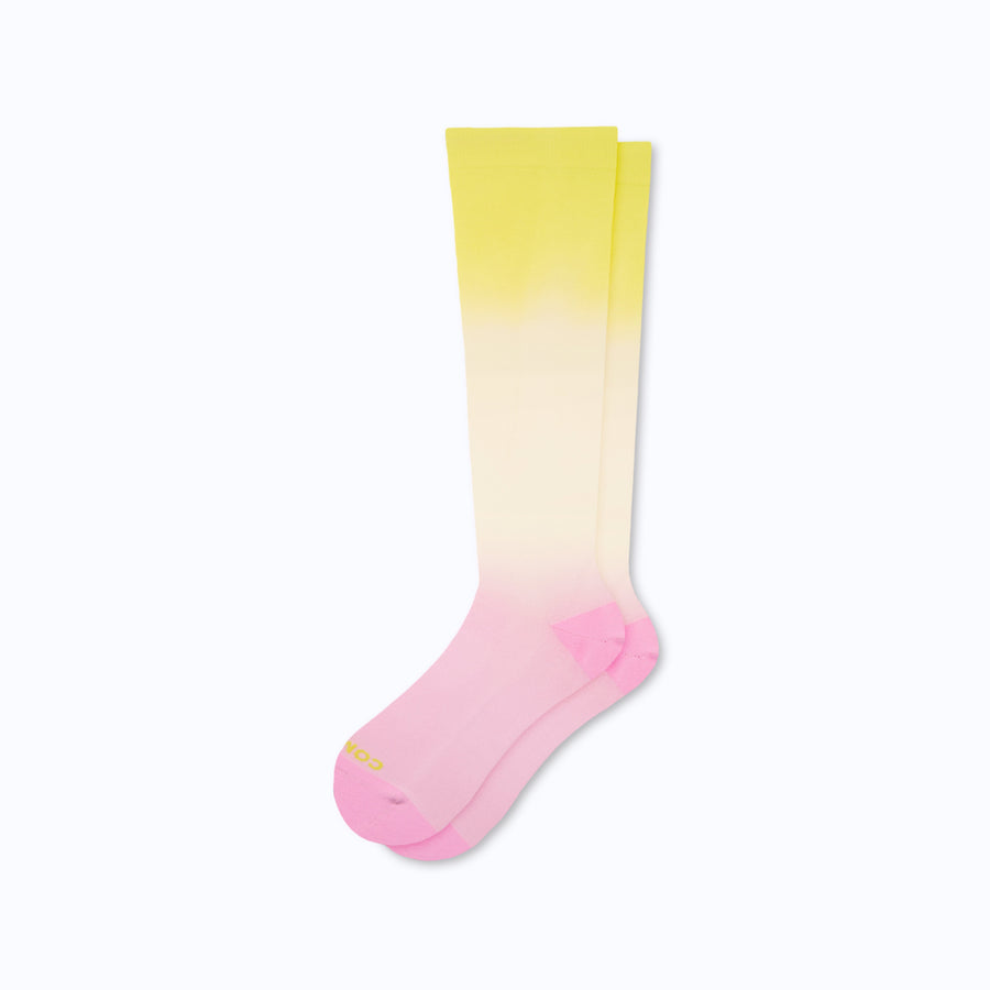 a pair of nylon knee high compression socks in neon pink