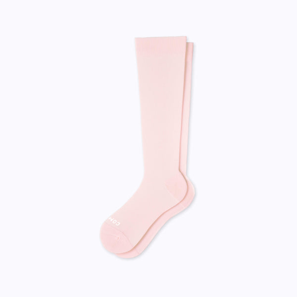 A pair of nylon knee high compression socks in rose solid