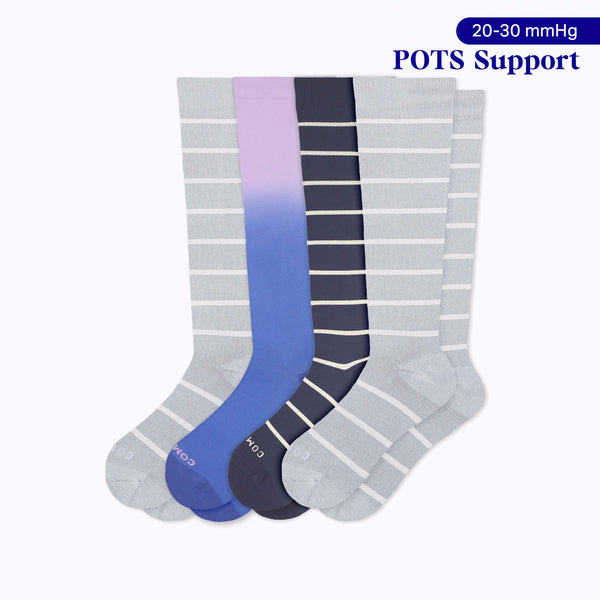 Four knee-high 20–30 mmHg compression socks in heather with white stripes, purple denim ombre, and navy with sand stripes for POTS support