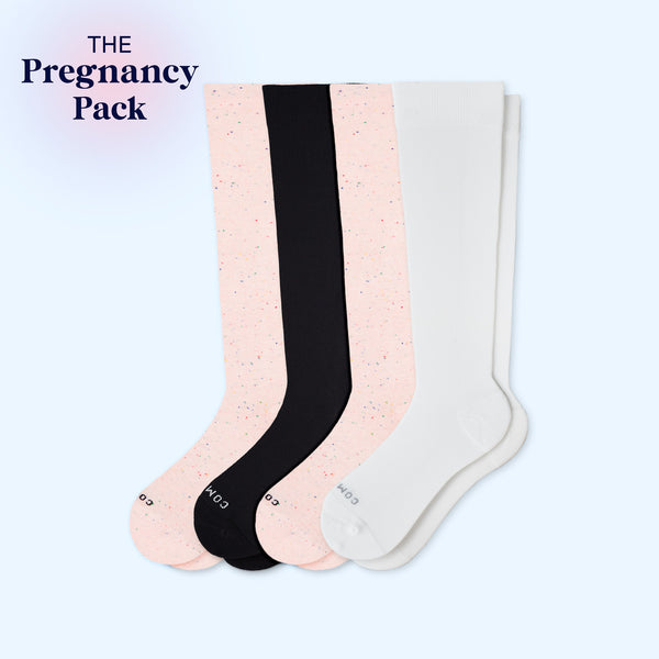 Four pairs of knee-high socks in black, pink, and white on a light blue background with 'The Pregnancy Pack' text.