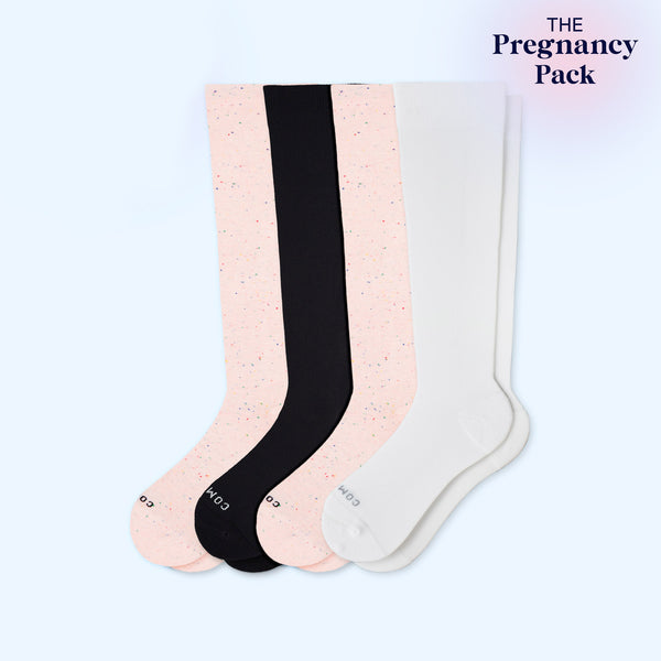 Four pairs of knee-high socks in black, pink, and white on a light blue background with 'The Pregnancy Pack' text.