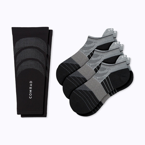 a pair of a black calf sleeve and three pairs of black and grey ankle socks