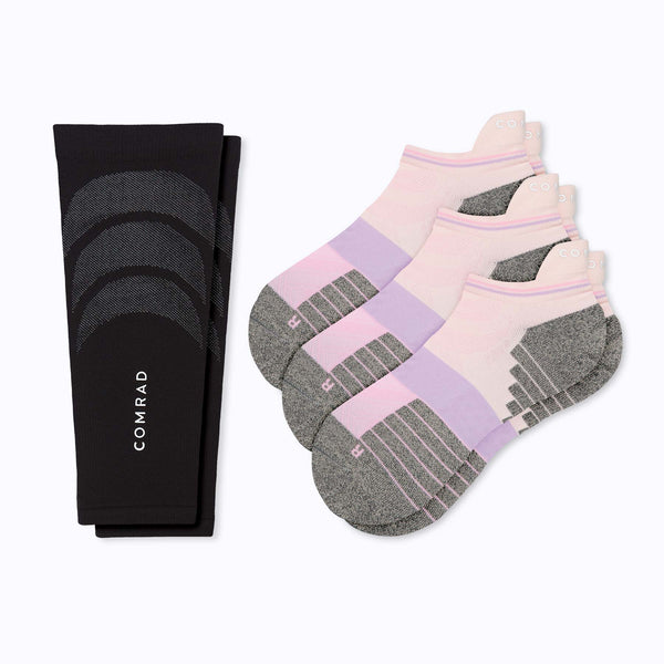 a pair of a black calf sleeve and three pairs of black and sand colored ankle socks