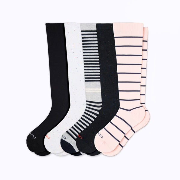 Set of five pairs of knee-high socks in black, white, gray, and pink with striped pattern on a white background.