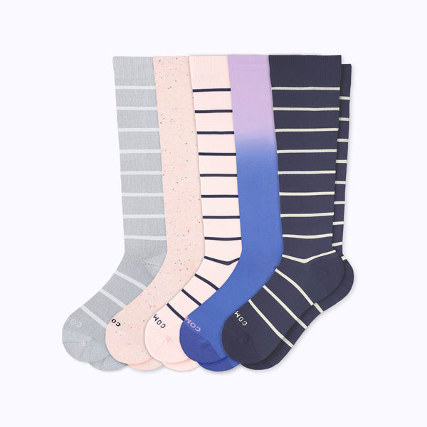 Five knee-high 20–30 mmHg compression socks in purple denim, heather with white stripes, rose, rose with navy stripes, and navy with sand stripes