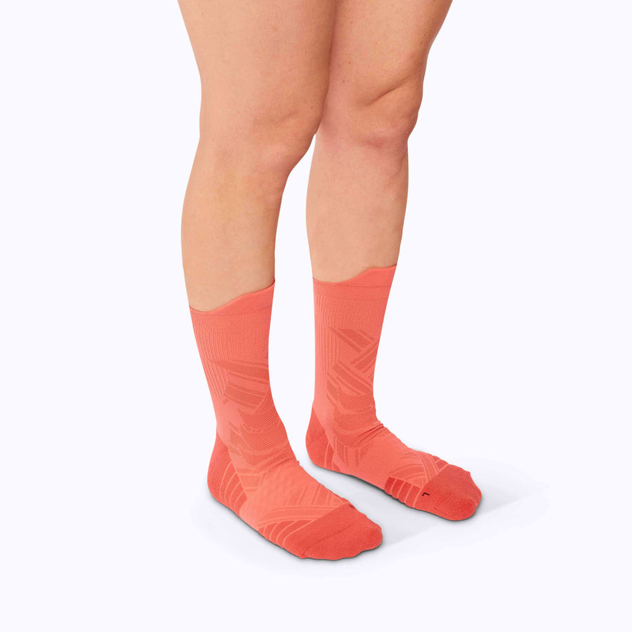 Side view of a pair of legs wearing performance blend coral solid