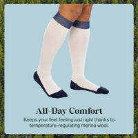 White knee-high socks with blue accents worn by a person, set against a natural background.