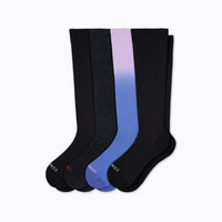 Set of black knee-high socks with gradient blue and purple design on a white background