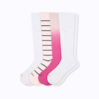 Set of three knee-high socks with gradient and striped patterns on a white background