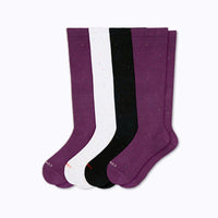 Set of four knee-high socks in potent, white, and galaxy on a white background