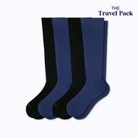 Two pairs of galaxy black and navy blue socks labeled 'The Travel Pack' on a white background.