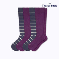 Two pairs of knee-high socks with colors navy sand stripes and potent purple on a white background, labeled 'The Travel Pack'.