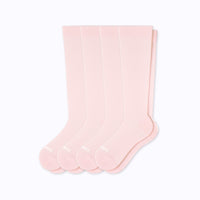 Set of four pink knee-high socks on a white background
