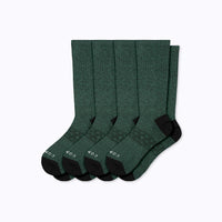 Set of five green socks with black accents on a white background