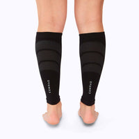 Back view of feet wearing a calf compression sleeve performance blend black solid