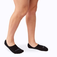 Side view of feet wearing the combed cotton loafer liners in black solid
