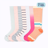 Set of seven pairs of colorful knee-high socks on a white background