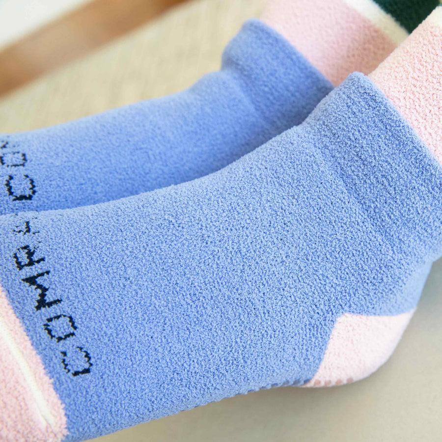 close up of cozygrip slipper socks in multi stripe