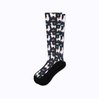 Knee-high socks with llama pattern on a white background