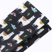 Set of socks with llama and rainbow patterns on a black background
