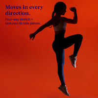A woman in a white sports bra and dark leggings is shown in silhouette against a bright orange-red gradient background, performing a high-knee movement. Blue text on the left reads, 'Moves in every direction.