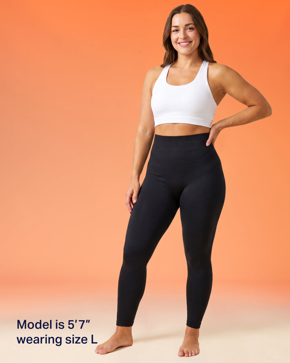 A woman modeling black high-waisted leggings and a white sports bra against a warm orange gradient background. Text in the lower left reads 'Model is 5'7" wearing size L'.