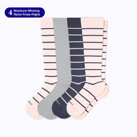Four pairs of knee-high socks displayed together on a light gray background. The set includes one solid gray pair, one navy blue pair, and one pale pink pair with thin navy horizontal stripes.