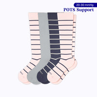 Four knee-high 20–30 mmHg compression socks in two rose with navy stripes, one heather grey, and one navy with sand stripes for POTS support