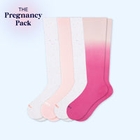 Set of four pairs of gradient socks in pink, white, and light pink on a light blue background.
