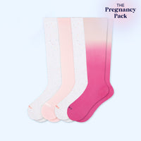 Set of four pairs of gradient socks in pink, white, and light pink on a light blue background.