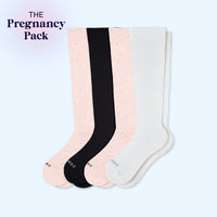 Four pairs of knee-high socks in black, pink, and white on a light blue background with 'The Pregnancy Pack' text.