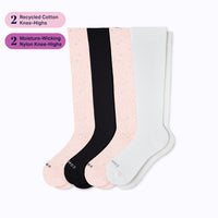 Set of four knee-high socks in black, pink, and white on a white background