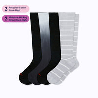 Four pairs of knee-high socks, one black and gray gradient, one gray with white stripes, on a light grey background.