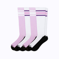 Four knee-high socks arranged in a fan shape on a white background. The socks feature a color-blocked design with light pink, white, and black sections, accented with purple stripes near the top.