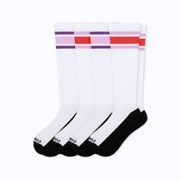 Four white crew socks with black toes and heels, featuring purple and pink stripes with a red stripe on the upper cuff, arranged in a fan shape on a white background.