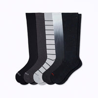 Set of five pairs of knee-high socks in black, gray, and white on a white background.