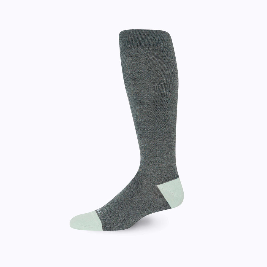 Side view of knee high compression socks in black-blue-sage