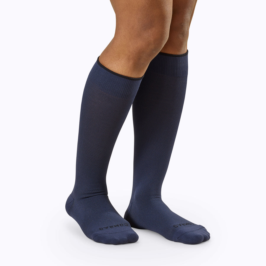 Front view of a pair of legs wearing nylon knee high compression socks in navy solid