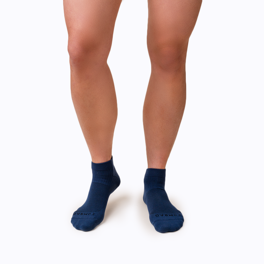 Front view of feet wearing nylon ankle socks in navy solid