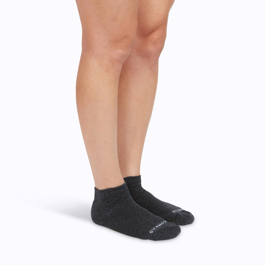 Side view of feet wearing nylon ankle socks in heather-charcoal solid