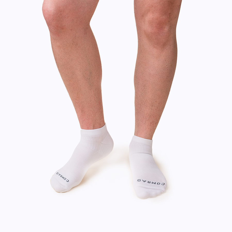 Front view of feet wearing nylon ankle compression socks in white solid