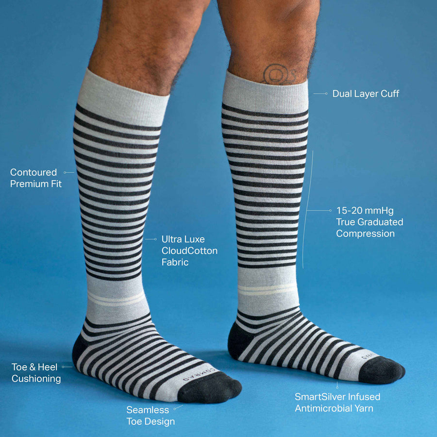 Side view of legs wearing a cotton compression socks in grey-black tencel stripe