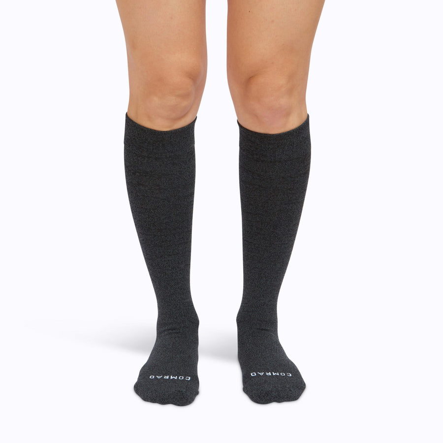 Front view of a pair of legs wearing nylon knee high compression socks in heather-charcoal solid