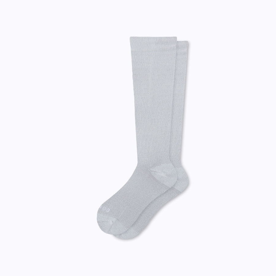 A pair of nylon knee high compression socks in heather-grey solid